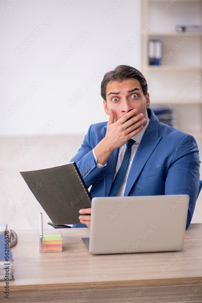 Young male employee working in the office Young male employee working in the office