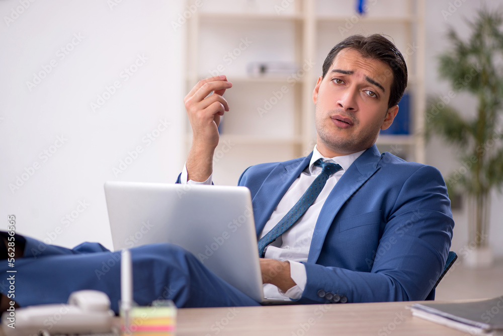 Young male employee working in the office Young male employee working in the office
