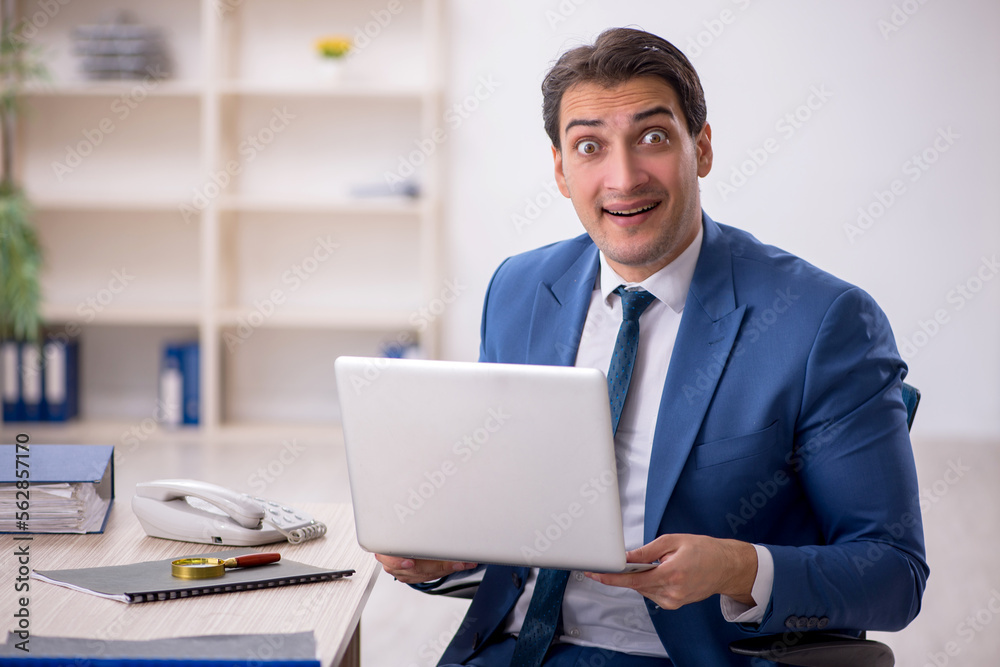 Young male employee working in the office Young male employee working in the office