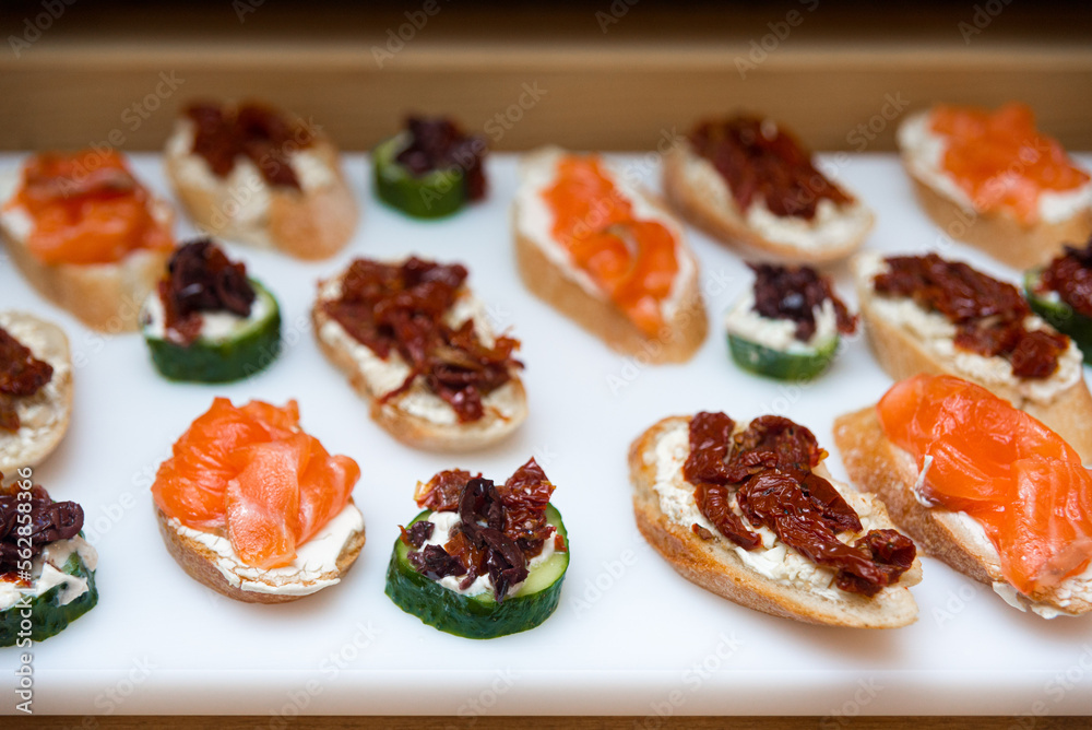 tapas appetizer with salmon and cream cheese, tapas with sun-dried tomatoes