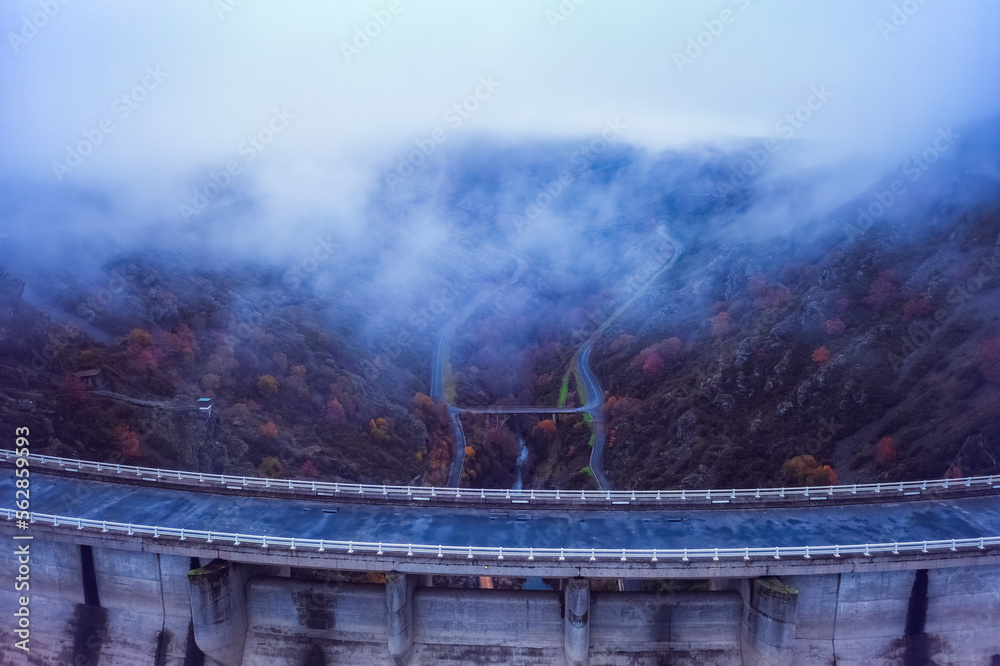 Autumn misty mountain with dam cold background