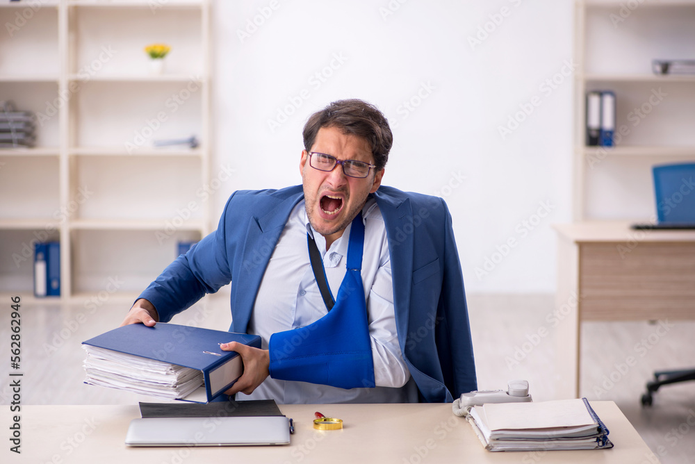 Young male employee after car accident at workplace Young male employee after car accident at workplace