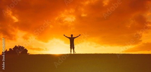 Man with arms outstretched to the sky with feelings of happiness, freedom, and hope 