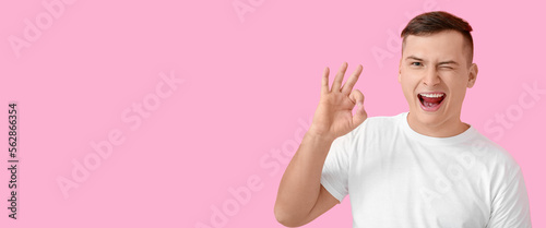 Happy young man showing OK ...