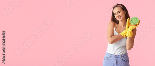 Cute young woman with sponge on pink background with space for text