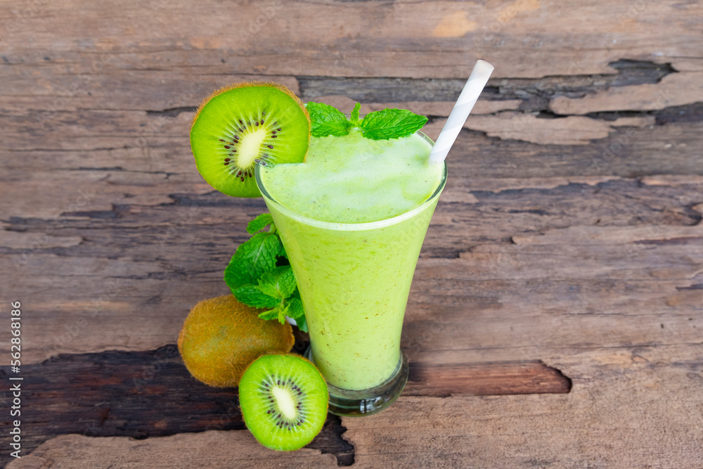 Kiwi yogurt fruit juice smoothie green colorful fruit juice milkshake blend beverage healthy high protein the taste yummy In glass drink episode morning on wood background. Kiwi yogurt fruit juice smoothie green colorful fruit juice milkshake blend beverage healthy high protein the taste yummy In glass drink episode morning on wood background.