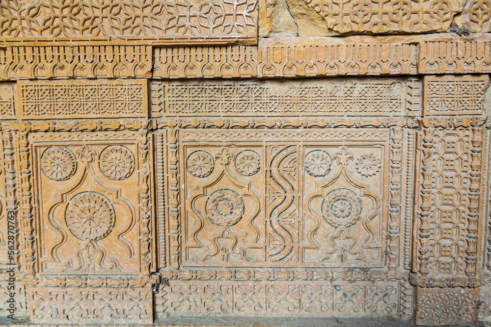 Beautiful traditional intricate geometric and floral carved stone detail, decoration, in a royal mausoleum in Makli necropolis in Thatta, Sindh, Pakistan