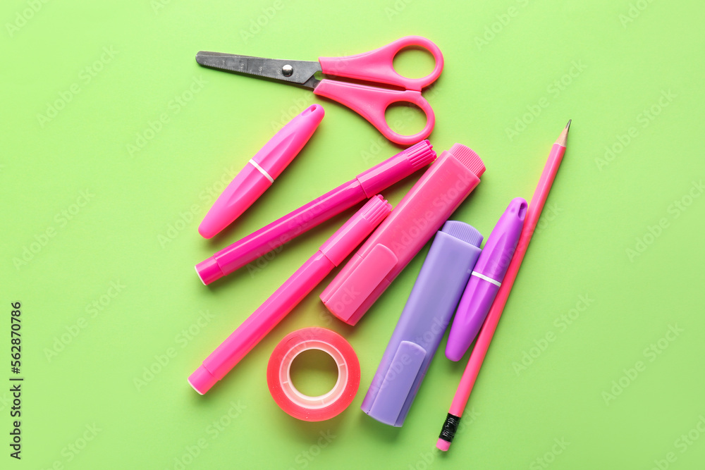Set of stationery with scissors on green background Set of stationery with scissors on green background