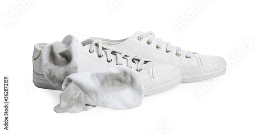 Dirty socks and sneakers on white background