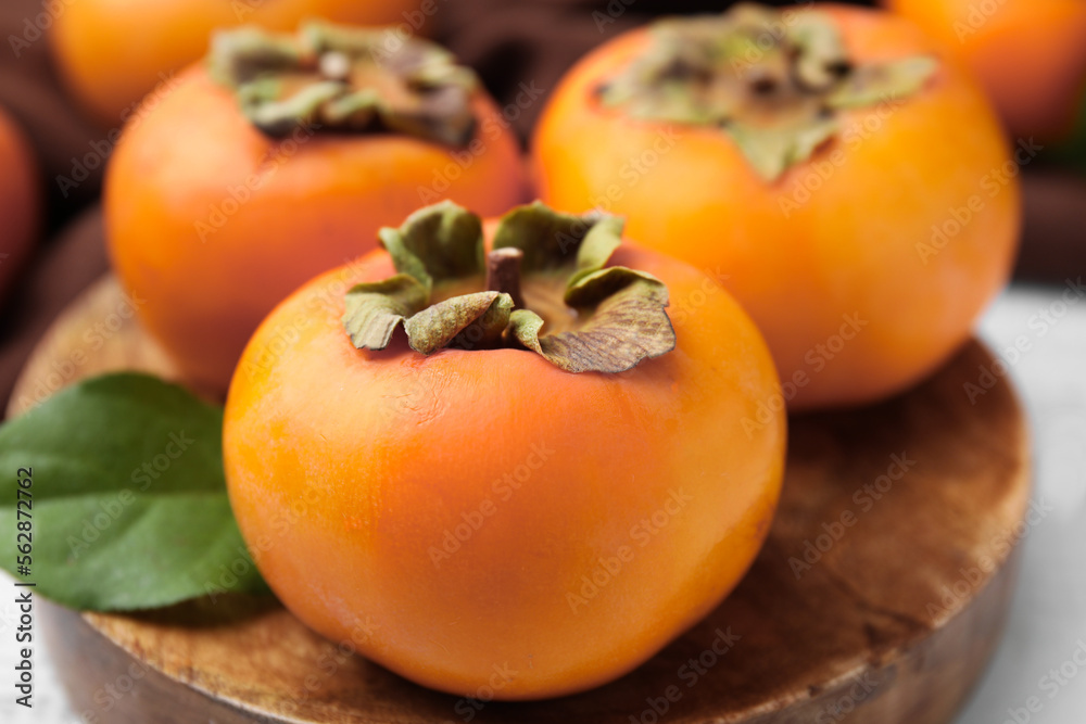Delicious ripe juicy persimmons on table, closeup Delicious ripe juicy persimmons on table, closeup