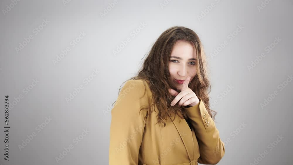 Young lady posing for camera smiling and having fun fooling around. Isolated portrait of young caucasian woman with long curly hairstyle who looking charming. Theme of strong active woman in business Young lady posing for camera smiling and having fun fooling around. Isolated portrait of young caucasian woman with long curly hairstyle who looking charming. Theme of strong active woman in business