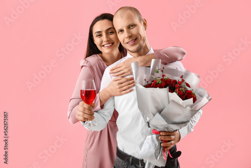 Young couple with flowers a...