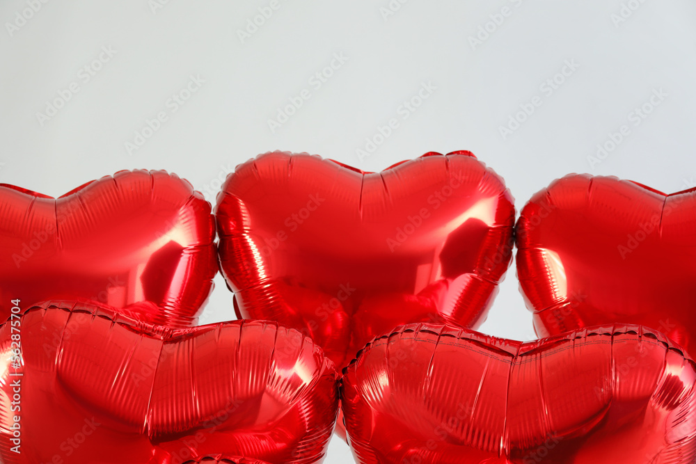 Heart shaped balloons for Valentine's Day on light background, closeup