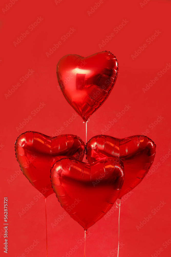 Heart shaped balloons for Valentine's Day on red background
