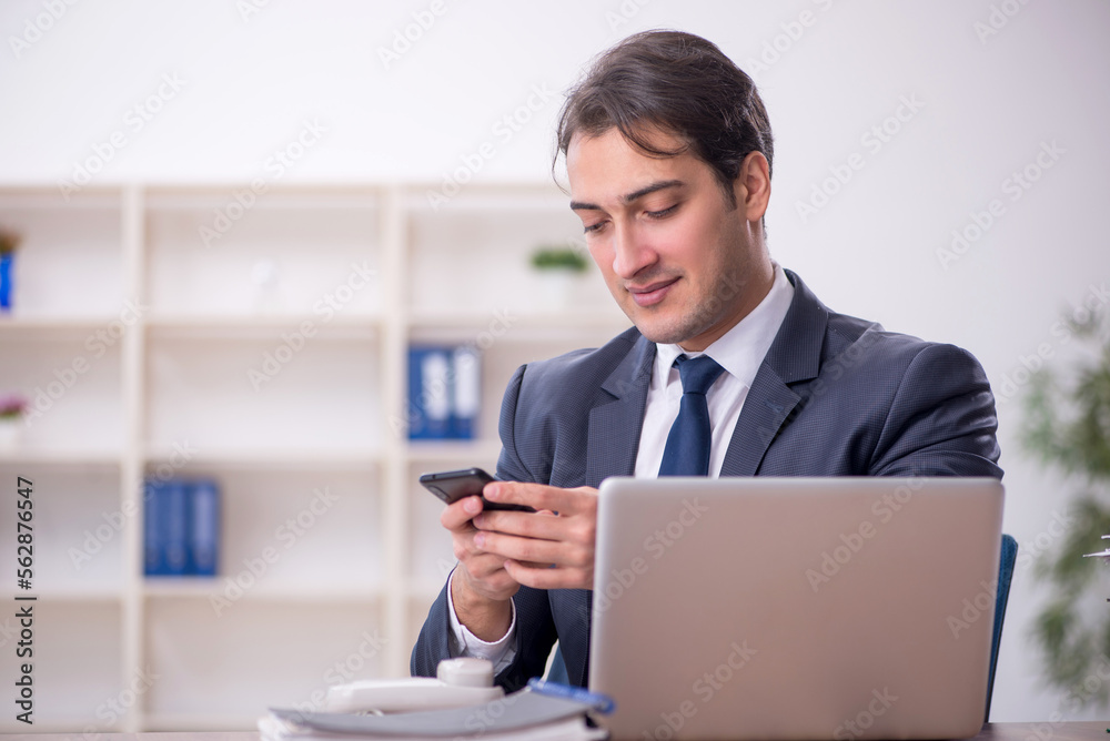 Young male employee working in the office Young male employee working in the office