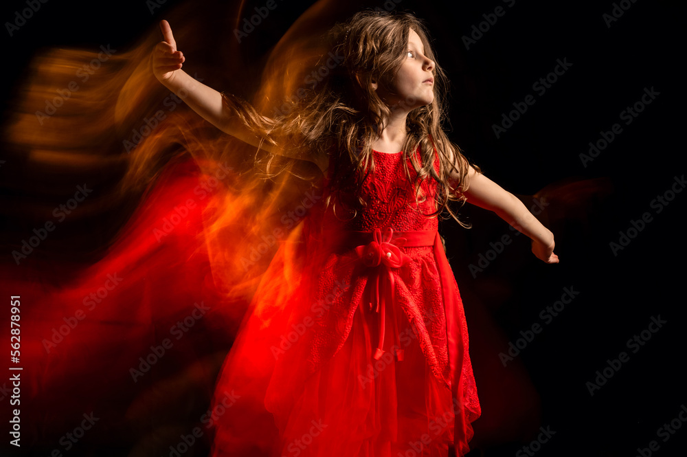 Naklejka premium Portrait of a cute little girl dancing