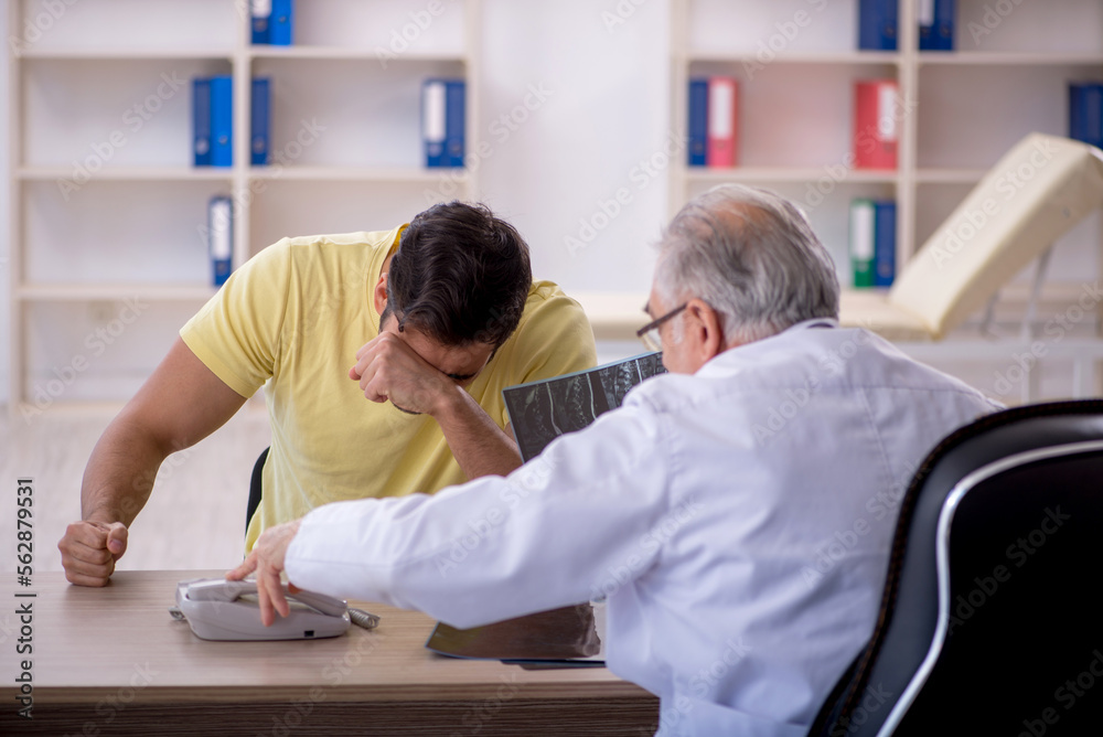 Young male patient visiting old male doctor
