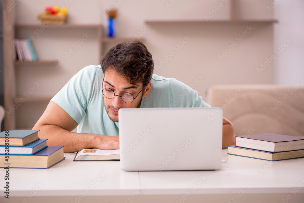 Young male student preparing for exams at home Young male student preparing for exams at home