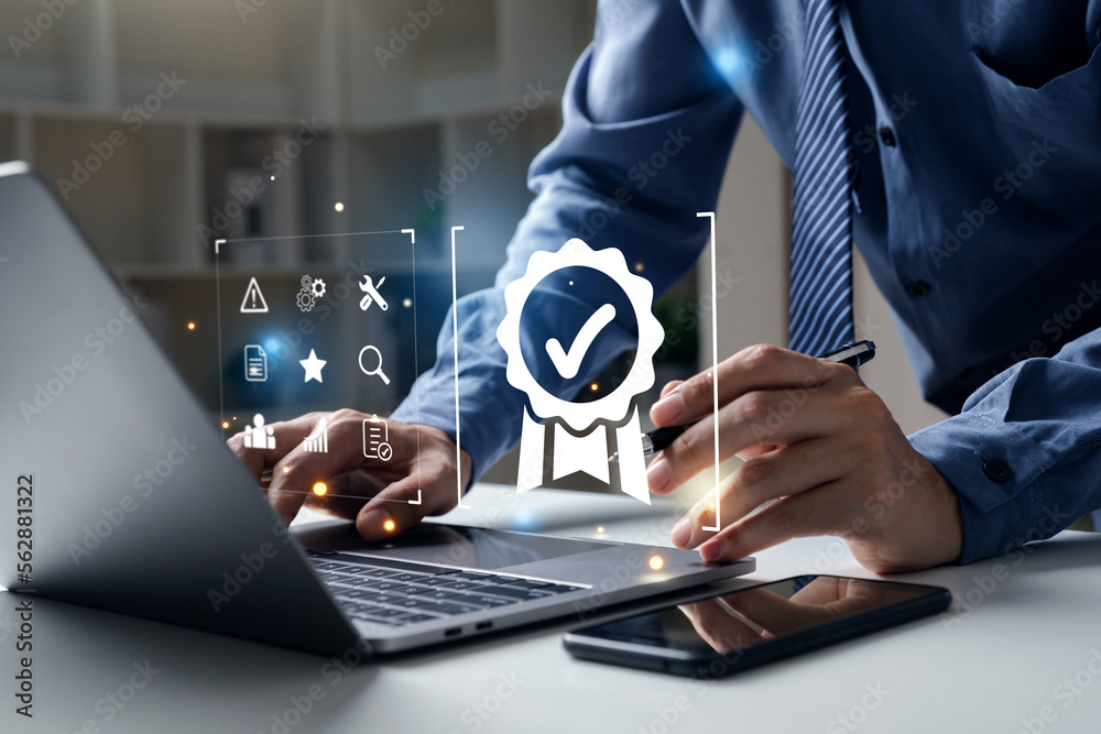 Young business pointing to quality assurance icon for Service Guarantee, ISO certification and standardization concept. Young business pointing to quality assurance icon for Service Guarantee, ISO certification and standardization concept.