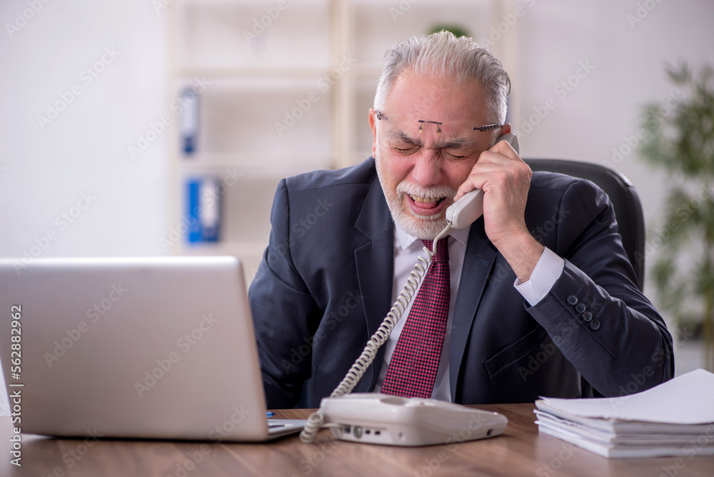 Old male employee and too much work in the office Old male employee and too much work in the office