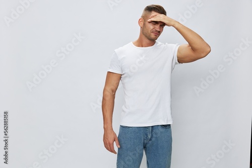 Man headache, migraine, high fever, in white T-shirt on white isolated background, copy space