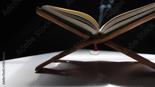 Slow motion The Quran in the mosque is placed on a wooden board. ,Is an important book of Muslims in Islam.Black background.