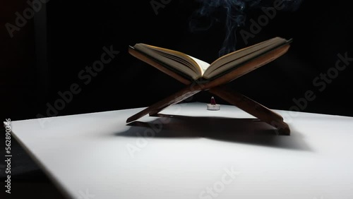 Slow motion The Quran in the mosque is placed on a wooden board. ,Is an important book of Muslims in Islam.Black background.