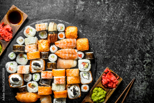 Delicious Japanese rolls with sauce and chopsticks.