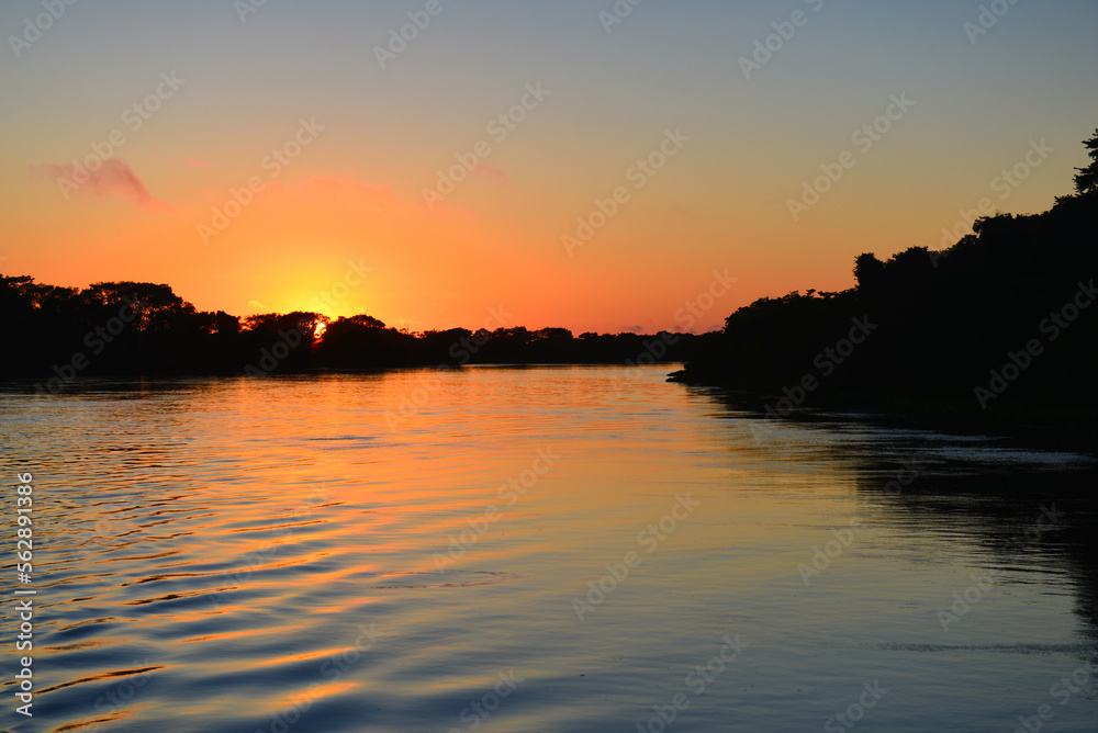 Sunrise on the rainforest-lined Guaporé-Itenez river near the remote village of Remanso, Beni Department, Bolivia, on the border with Rondonia state, Brazil Sunrise on the rainforest-lined Guaporé-Itenez river near the remote village of Remanso, Beni Department, Bolivia, on the border with Rondonia state, Brazil