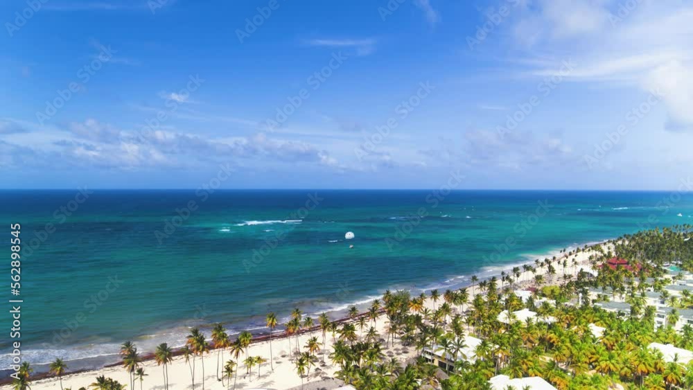 Aerial view of the tropical resort of Punta Cana on Bavaro Beach in the Dominican Republic. Ocean top view. Beautiful Atlantic tropical beach with palm trees, umbrellas and parasailing balloons. Aerial view of the tropical resort of Punta Cana on Bavaro Beach in the Dominican Republic. Ocean top view. Beautiful Atlantic tropical beach with palm trees, umbrellas and parasailing balloons.