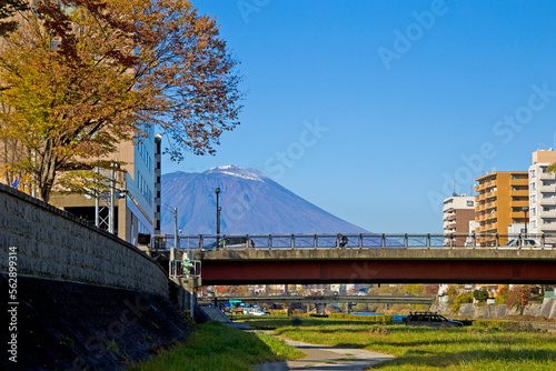 Mount Iwate scene with buildings and promenade at Katakami river in  Morioka city, Iwate prefecture, Tohoku, Japan. © Tanya