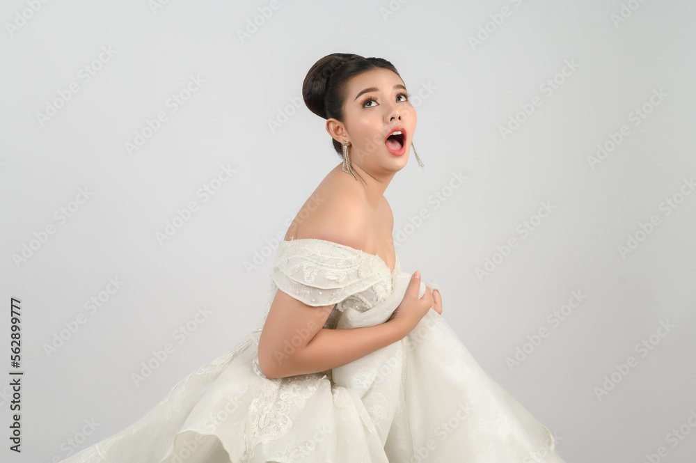 Young asian beautiful bride pose with excited feel on white background Young asian beautiful bride pose with excited feel on white background