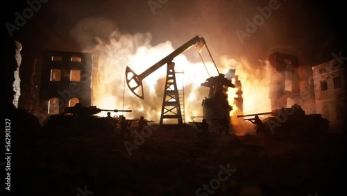 Artwork decoration. Oil war concept. Military silhouettes at oilfield with pumps and rigs. Misty colorful sky background. Armored vehicles fighting scene. Selective focus