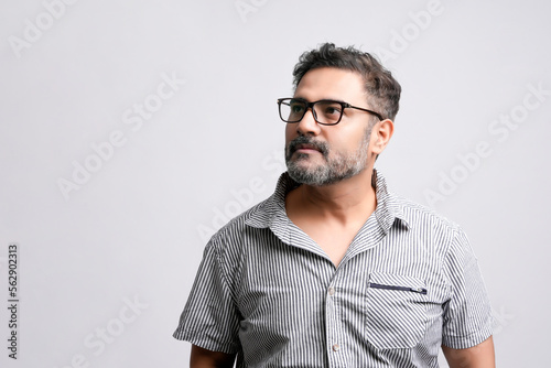 Young indian man in casual look on white background. © Niks Ads