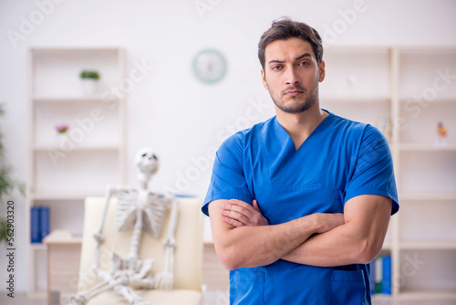 Young male doctor and skeleton patient at the hospital