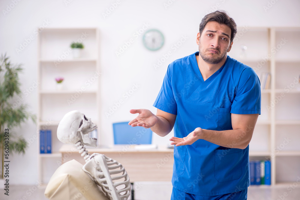 Young male doctor and skeleton patient at the hospital