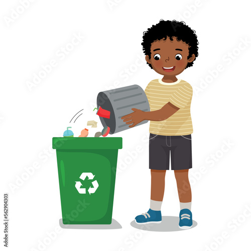 cute little African boy taking out the trash into recycling bin doing daily routine housework chores at home
