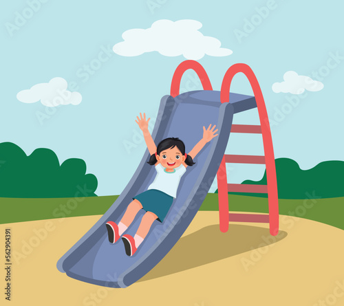 Cute little girl sliding down on slide in the playground 