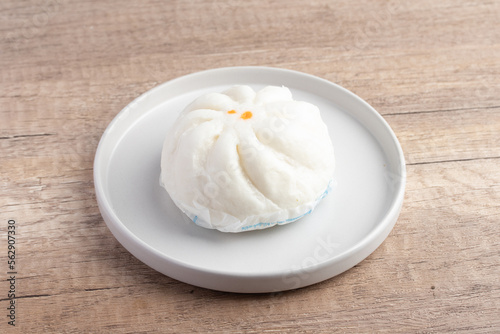 Steamed pork buns in a plate on a white background