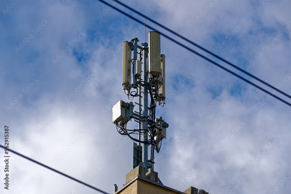 Mobile phone antennas on rooftop at City of Zürich on a blue cloudy autumn day. Photo taken December 8th, 2022, Zurich, Switzerland. Mobile phone antennas on rooftop at City of Zürich on a blue cloudy autumn day. Photo taken December 8th, 2022, Zurich, Switzerland.