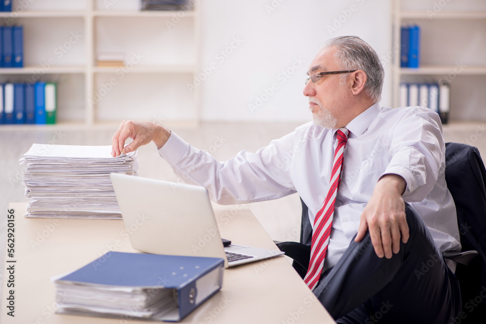 Old male employee and too much work at workplace Old male employee and too much work at workplace
