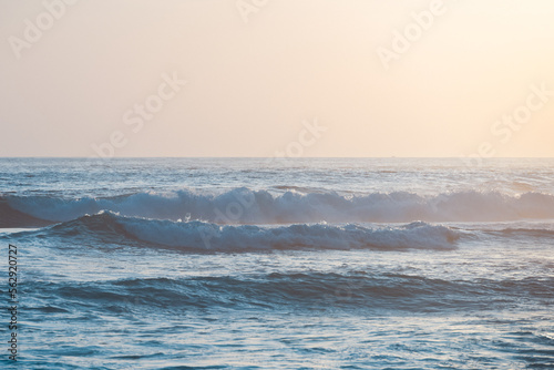 (Selective focus) Stunning view of some ocean waves breaking on the shore during a beautiful sunset. Crushing waves, ocean waves relaxation. Bali, Indonesia. © Travel Wild