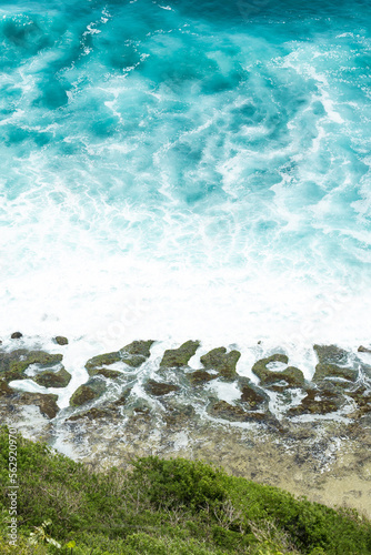Obraz na płótnie (Selective focus) Stunning view of some ocean waves breaking on the shore during a beautiful sunny day. Crushing waves, ocean waves relaxation. Bali, Indonesia. w salonie
