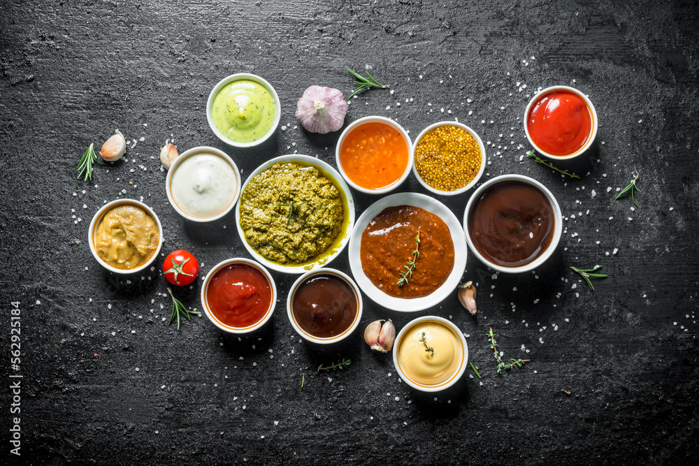Set of sauces - tomato sauce, pesto, mustard, barbecue sauce, guacomole, mayonnaise. Set of sauces - tomato sauce, pesto, mustard, barbecue sauce, guacomole, mayonnaise.