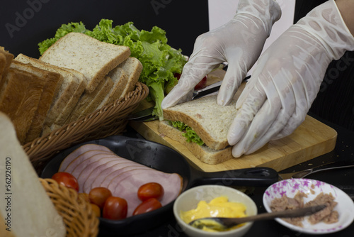 Chef preparing bread to make sandwiches for breakfast.