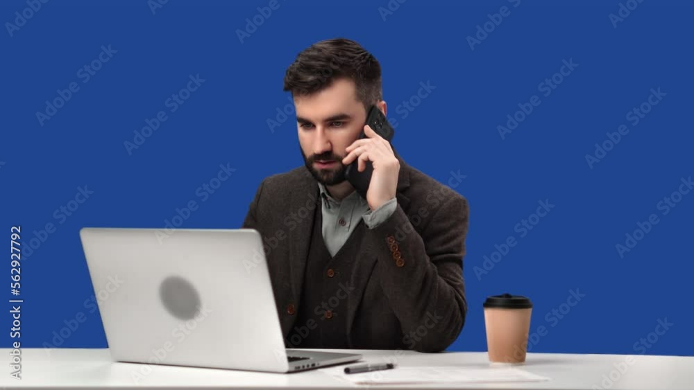 Business man in suit call smartphone discuss deal use laptop desk isolated blue screen chroma key Business man in suit call smartphone discuss deal use laptop desk isolated blue screen chroma key