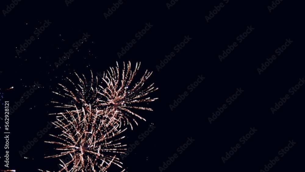 Fireworks display celebration for New year's eve with abstract multicolor big shining glowing fireworks show with bokeh lights in the night sky. Vertical Footage Fireworks display celebration for New year's eve with abstract multicolor big shining glowing fireworks show with bokeh lights in the night sky. Vertical Footage