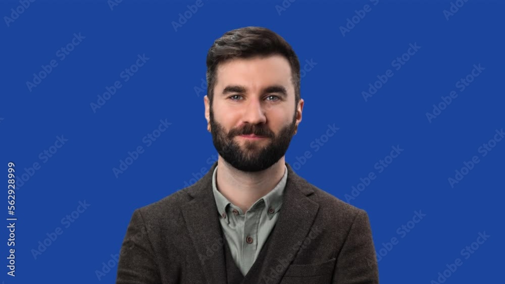 Smiling modern business man in suit posing with positive emotion isolated blue screen chroma key