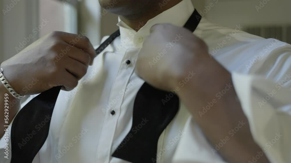 Groom getting ready on his wedding day, tying bow tie. Shot in 4K 60 FPS. To purchase entire event raw at wholesale price email willneatheryyahoo.com.