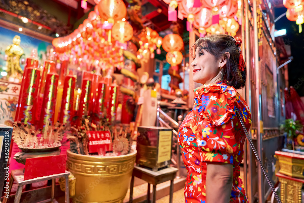 thai woman at temple in yaowarat china town bangkok during chinese new year wearing cheongsam